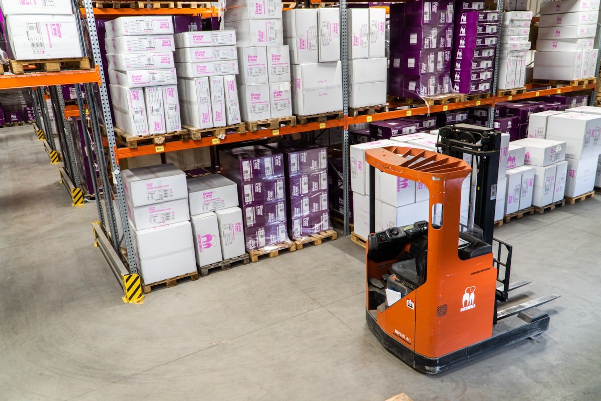 Factory operator monitoring manufacturing KPIs using a digital barcode scanner and mobile tablet